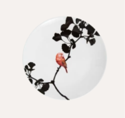 Porcelain plate with solitary red bird perched on black ginkgo branch